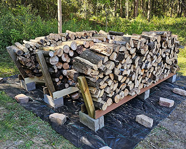 about a cord of firewood split and stacked